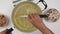 Frying chopped onion close up on frying pan. Flat lay, white kitchen table background