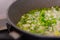Frying green onions in a pan with vegetable oil. Home cooking. Soup ingredients. Chopped vegetables.