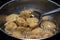 FRYING INDIAN SUBCONTINENT FOOD NAMED PAKORA ALOO BHAJIYA IN OIL