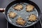 Frying latkes on the pan from side