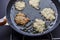 Frying latkes raw side up one turned