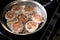 Frying meatballs on the stove in a frying pan