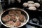 Frying meatballs on the stove in a frying pan