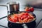 Frying minced pork with vegetables on olive oil.