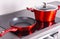 Frying pan and steel pot on modern induction cooktop