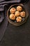 Frying pan with tasty sausage balls on table, top view