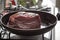 Frying a pice of beef meat in the pan