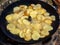 Frying potatoes in oil on a improvised pan