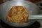 Frying a rounded and crisp Indian- Poori till it gets crispy and golden brown in the oil pan