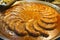 Frying rounded sausages in huge bowl