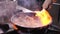 Frying shrimps in a small pan - flaming the food