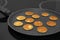 Frying tasty cereal pancakes on modern stove