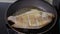 Frying Tilapia fish in a pan with hot oil