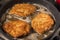 Frying wiener schnitzel in a hot pan