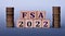 FSA 2022 - acronym on wooden cubes on a light background with coins