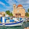 Fshing boats and waterfront with church in Aegina town
