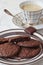 Fudge brownie cookies on crockery plate and cup of coffee