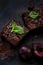 Fudge Brownies with Fruits on Dark Background