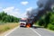 Fuel carrier in flames. Truck burning on the road. Neural network AI generated