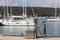 Fuel distributor on the pier of a gas station in the Mediterranean marina against the backdrop of sailing yachts. Refualing boats