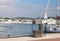 Fuel distributor on the pier of a gas station in the Mediterranean marina against the backdrop of sailing yachts. Refualing boats