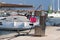 Fuel distributor on the pier of a gas station in the Mediterranean marina against the backdrop of sailing yachts. Refualing boats