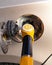 Fuel pump inserted in the gas tank hatch. Refueling a passenger car with gasoline. Yellow fuel pump with number 92 petrol ,