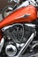 Fuel tank and engine of Kawasaki Vulcan 900 Classic motorcycle. Motorcycle detail in red, logo. Shining chrome engine parts.
