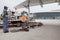 Fuel truck and fuel truck driver refueling an airplane on apron of Tianjin Binhai International Airport