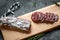 Fuet Catalan dry cured sausage cut in slices. Traditional Spanish Fuet thin dried sausage