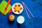 Fuit snack for clildren. Fruits and milk on blue table background top view copyspace