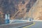 Fujairah mountains, extension of Omani Al Hajar mountain range. Cloudy winter day on empty street.