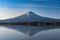 Fuji mountain reflecting its shadow in kawaguchiko lake in the morning light