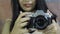 Fujifilm X-T200 mirrorless camera closely scrutinized by a long-haired beautiful teenage girl with beautifully manicured hands.