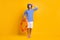 Ful size photo of excited guy hold life buoy touch scuba goggles wear blue striped shirt shorts isolated on yellow color