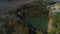 Full aerial drone circle view right to left of triangle lake surround by trees