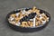 Full ashtray of cigarettes on table, close-up