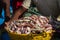 A full basket of fresh fish. A fishing boat at the unloading port.