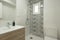 Full bathroom with shower with hydraulic tile wall, glass partition