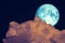 Full Beaver Moon back dark orange cloud on night sky
