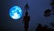 Full blue harvest moon moving on night sky and silhouette buddha