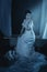 full body beautiful girl ghost, witch, bride sitting on a vintage copper bath with a white canopy, in a long white dress with