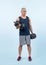 Full body length shot active and sporty senior man lifting dumbbell. Clout