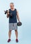 Full body length shot active and sporty senior man lifting dumbbell. Clout