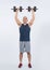 Full body length shot active and sporty senior man lifting dumbbell. Clout