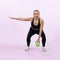 Full body length shot athletic senior woman doing squat with weight. Clout