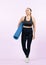 Full body length shot athletic and sporty senior woman with fit mat. Clout