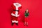 Full body photo of astonished santa claus with his granddaughter in green elf costume scream omg see noel incredible