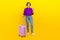 Full body photo of attractive young woman device suitcase dressed stylish purple smart casual clothes isolated on yellow