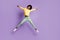 Full body photo of carefree afro american girl jump wear yellow sweater green trousers isolated over violet color